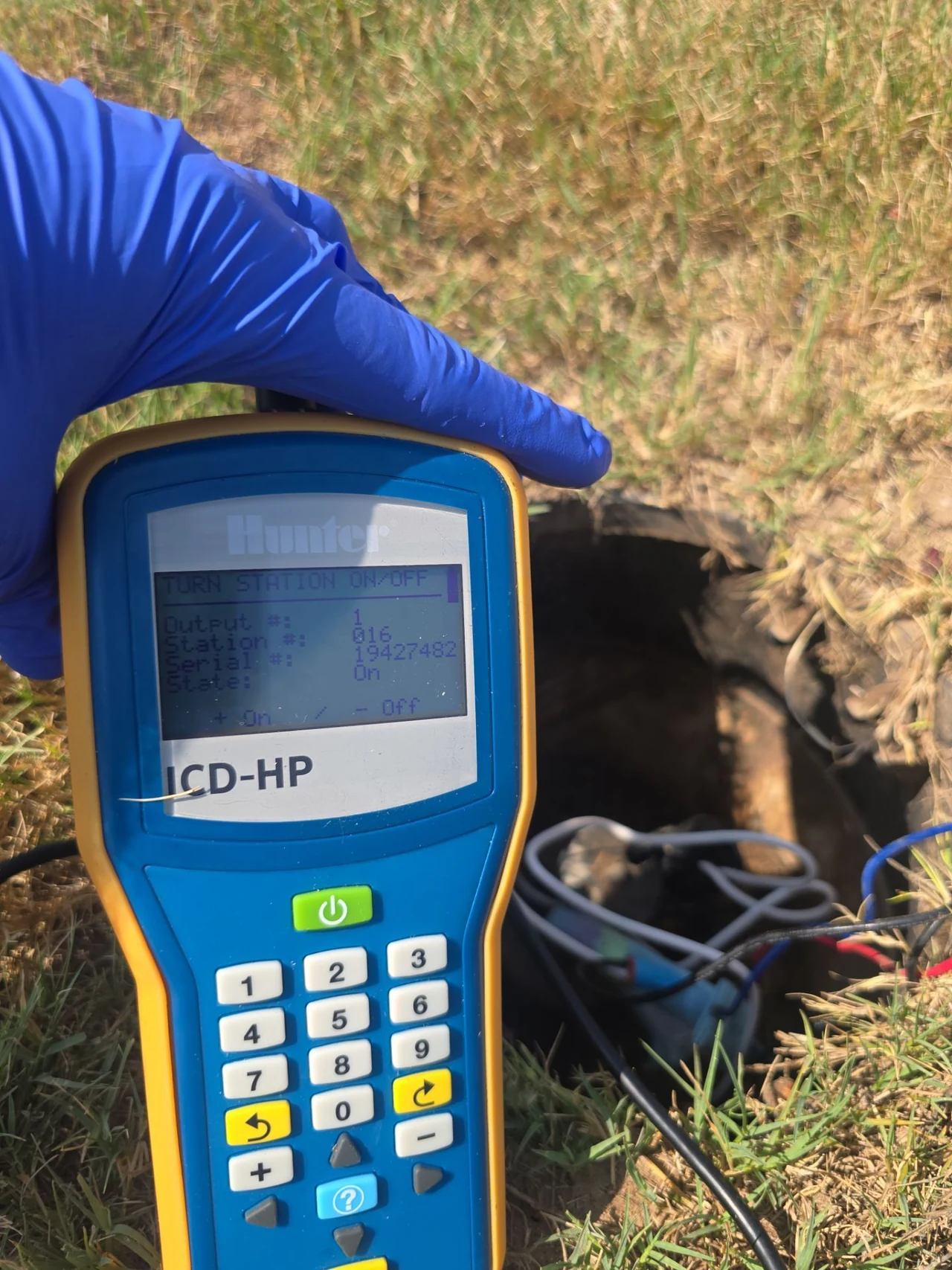 Hunter ICD-HP programmer showing station controls during field work.