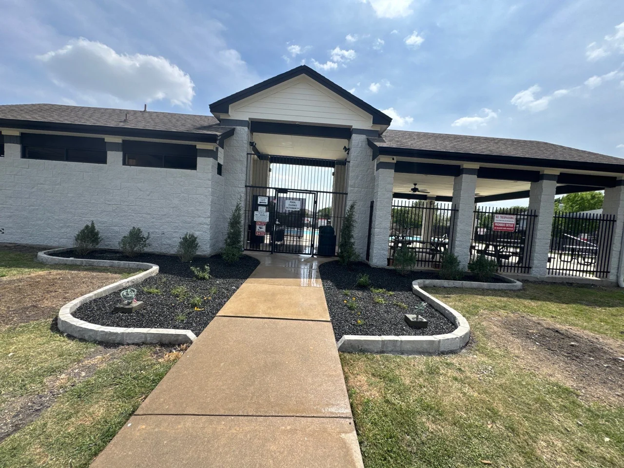 New planting and defined stone borders installed in a former grass area at the pool entry.