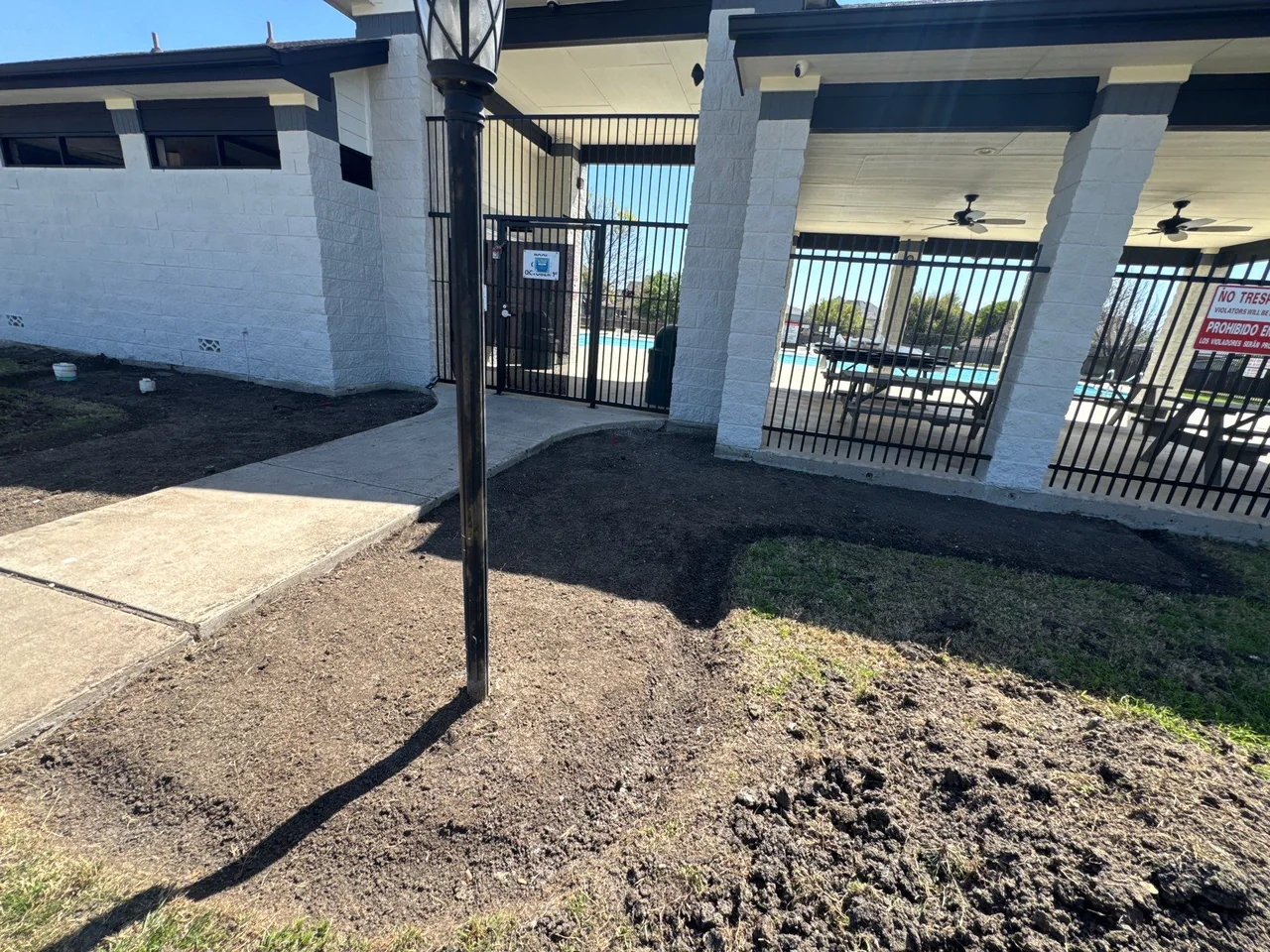 Pool-entry area before installation of a new landscape bed.