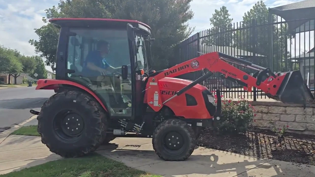 Tractor tipping mulch into a community landscape bed